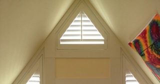 Triangle shaped window with plantation shutters